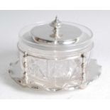 An Edwardian silver and glass butter dish and cover, the circular cut glass dish having finial