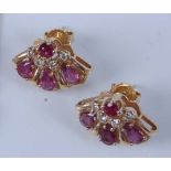 A pair of 14ct yellow gold, ruby and diamond fan shaped earrings, each featuring three pear shaped