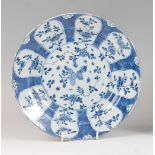 A Chinese export blue and white plate , probably Kangxi, decorated with reserves of flowers and