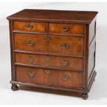 A circa 1700 oak and walnut fronted chest, of two short and three long drawers, in two sections, the