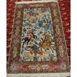 A Persian silk rug, late 20th century, the central ground decorated with huntsmen and wild animals