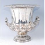 A circa 1900 silver plated pedestal wine cooler, of campagna form, having leaf cast rim and engraved