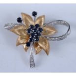 An 18ct yellow and white gold, sapphire and diamond floral brooch, featuring a centre cluster of ten