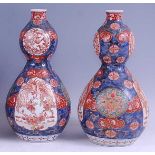 A pair of Japanese Meiji period double gourd vases, each decorated in the Imari pallette and