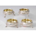 A set of four mid-Victorian silver table salts, each having gilt washed bowls with beaded rims,