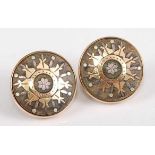 A pair of 9ct circular earrings, each comprising a centre panel of possibly vulcanite, inlaid with a