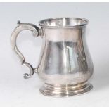 A George II silver bell-shaped tankard, having flying S-scroll handle, raised on a domed foot,