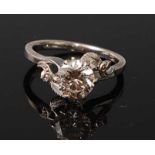 A white metal diamond solitaire ring, featuring a round brilliant cut diamond in a claw setting,