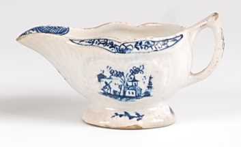 A Lowestoft porcelain moulded cream-boat, underglaze blue painted in the Fisherman & Sampan pattern,