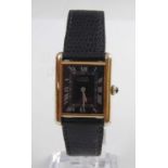 A silver gilt cased Must de Cartier tank quartz wristwatch, having rectangular black Roman dial