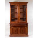 A Victorian mahogany bookcase cabinet, having glazed upper section, the serpentine base having blind