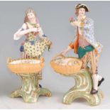 A pair of 19th century soft-paste porcelain figures of flower-pickers, each in the mid-18th