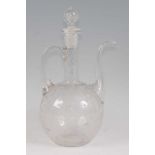 An Ottoman Empire style glass ewer and stopper, having elongated spout and high loop handle, all-