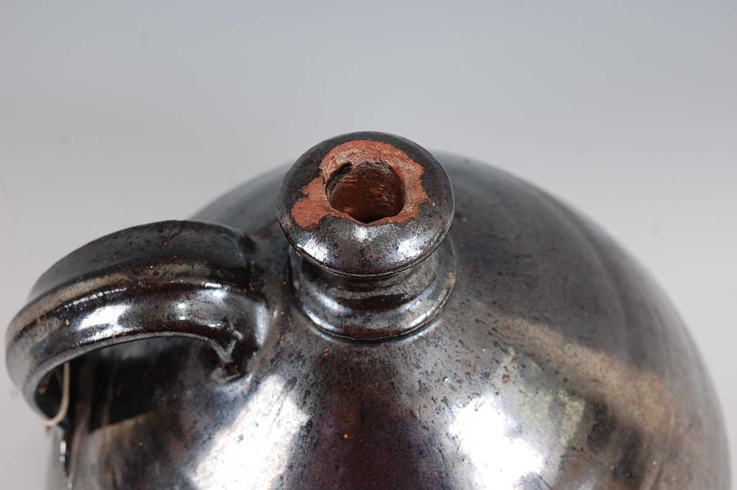 An early 19th century earthenware bellamine jug, of typical form, having silver lustre drip glaze, - Image 4 of 5
