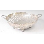 A George V silver fruit bowl, of pierced circular form and raised on claw feet, 11oz, maker