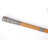 A circa 1900 Indian silver mounted and mallacca walking cane, the silver relief decorated with