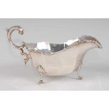 A silver sauce-boat in the Georgian style, having acanthus leaf capped double C-scroll handle, the