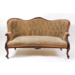 A Victorian rosewood framed double spoonback settee, the whole buttonback upholstered in a green