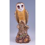 *A 19th century Meissen Dresden porcelain owl, modelled upon a treestump, glazed in bright