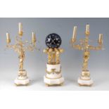 A 19th century French gilt bronze and white marble clock garniture, the clock modelled as three