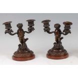 A pair of late 19th century French bronze twin branch dwarf figural candelabra, in the manner of