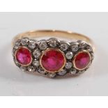 An Edwardian yellow and white metal synthetic ruby and old European cut diamond triple cluster ring,