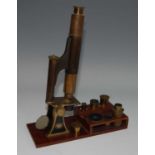 A late 19th century lacquered brass travel microscope, the monocular body within brass and iron