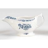 A Lowestoft porcelain moulded sauce-boat, underglaze blue transfer printed in the Three Flowers