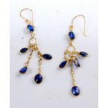 A pair of yellow metal sapphire multi-stone earrings, each featuring five oval faceted sapphires