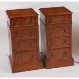 A pair of yew wood topped and fronted bedside chests, of four long graduated drawers, each with ogee