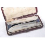 A cased pair of mid-Victorian silver and mother of pearl pocket knife and fork, each with fold-out