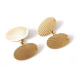 A pair of 18ct yellow gold double-ended oval cufflinks, with engraved sunburst pattern, in a