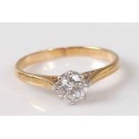 A yellow and white metal diamond solitaire ring, comprising a round brilliant cut diamond in an