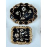 Two late Victorian yellow metal mourning brooches, one oval with scrollwork border and black
