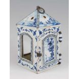 A circa 1900 Dutch delft candle lantern, with arched windows (lacking glass), hinged door, the whole