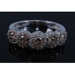 A 9ct white gold diamond half hoop eternity ring, comprising five graduated fancy light brown