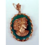 A yellow metal oval cameo habillé pendant, featuring a chrysoprase background with a yellow metal