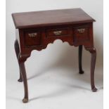 *A George III North Country oak and mahogany crossbanded lowboy, having a typical arrangement of