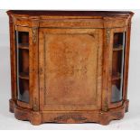 A Victorian figured walnut and satinwood inlaid serpentine credenza, enclosed by a single panelled