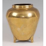 A Chinese cast polished bronze tripod vase, of ovoid tapering form, supported on three small applied
