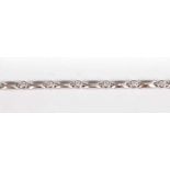 A white metal diamond line bracelet, having twelve round brilliant cut diamonds in bezel settings