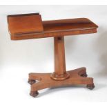 A William IV rosewood pedestal reading table, having twin hinged book-rests and raised on an