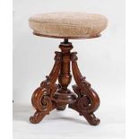 A late Victorian walnut music stool, having revolving stuffover seat, dia.37cm