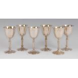 A set of six modern silver pedestal wine goblets, each having knopped and tapering stems, gilt