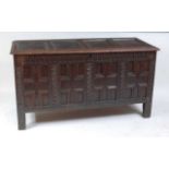 A circa 1700 joined oak four panel coffer, the hinged lid on original steel loop hinges, over a four