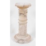 A late 19th century variegated white marble torchere, in sections and with ring turned decoration,