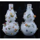 A pair of Sitzendorf flower and fruit encrusted double gourd vases, further painted with insects,
