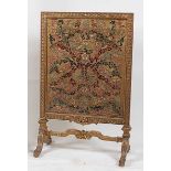 A Victorian giltwood and gesso fire screen, having 17th century stumpwork inset panel under glass,