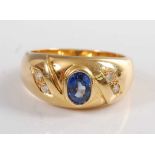 An 18ct yellow gold, sapphire and diamond 'Gypsy' style ring, comprising an oval sapphire in a bezel