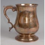 A late Victorian silver bell shaped tankard, having acanthus leaf clad flying S-scroll handle,